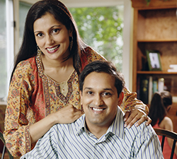 Indian couple paying bills at table
