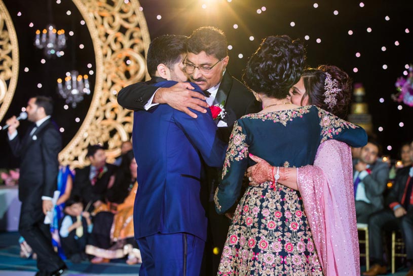 Indian Bride and Groom doing Hug with their Parents