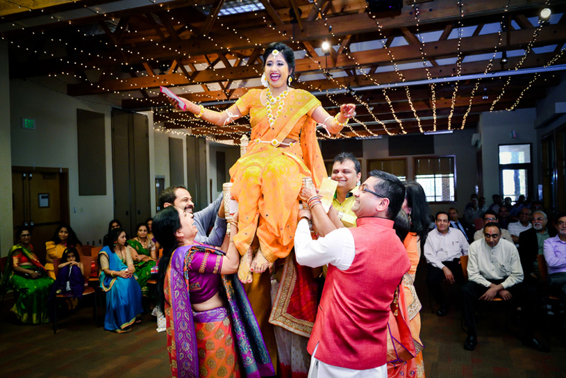Indian wedding ritual of painting the bride with yellow turmeric paste