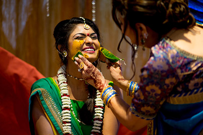 Haldi Ceremony - Painting Yellow Turmaric Paste to Indian Bride