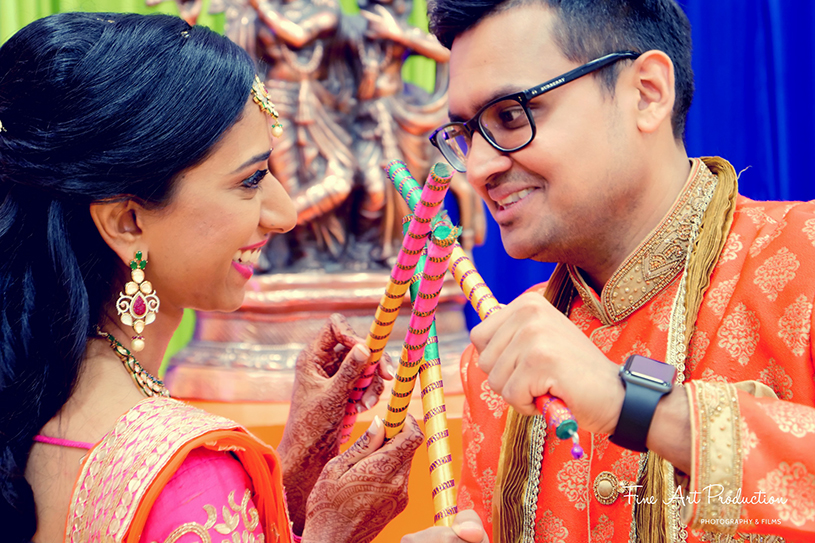 Groom and Bride Posing with the Dandiya