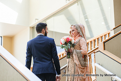 Groom greeting bride with flowers