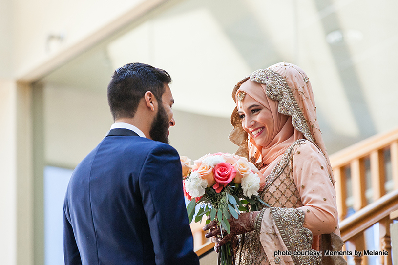 Stunning bride smiling with the groom as the photoshoot continues