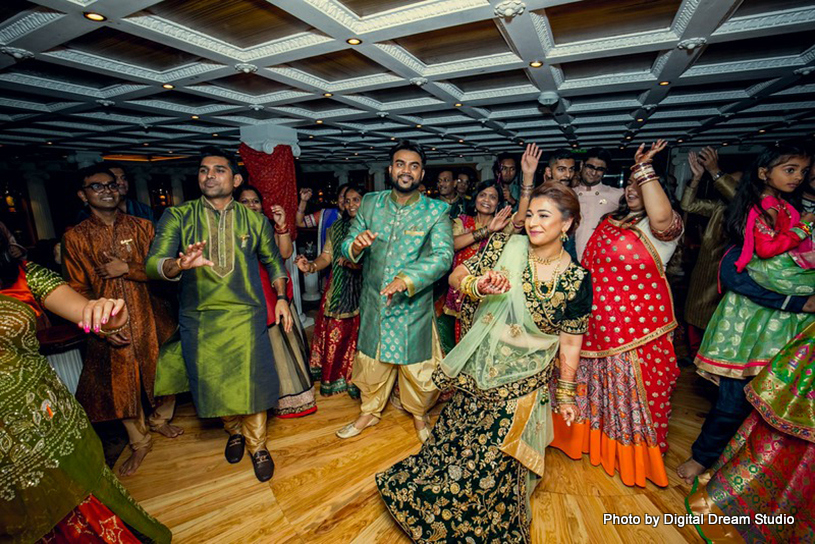 Gorgeous Indian bride at the wedding sangeet with her family and friends