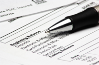A pen on top of a bank statement.