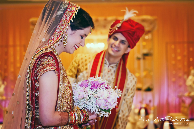 Bride blushing after groom presented her with flowers