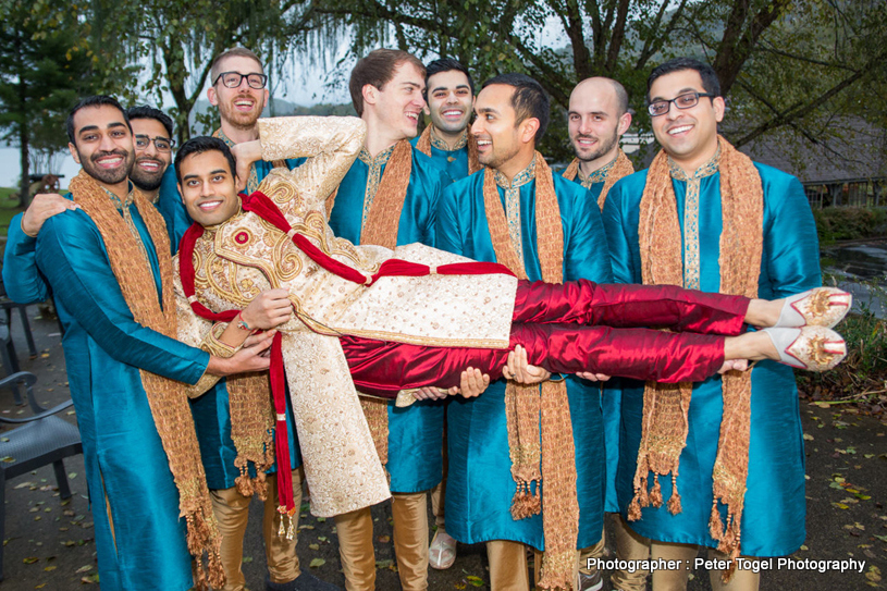 Friends carrying Groom just to have fun