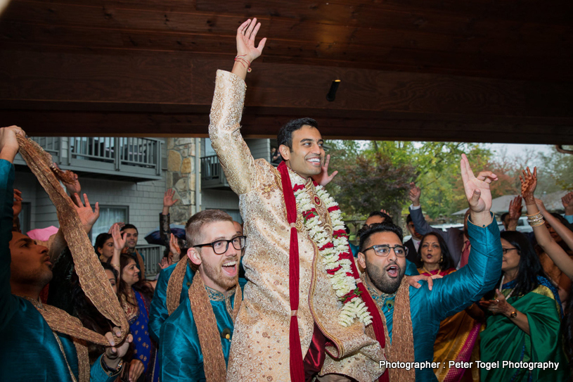 Groom dancing with the friends and family