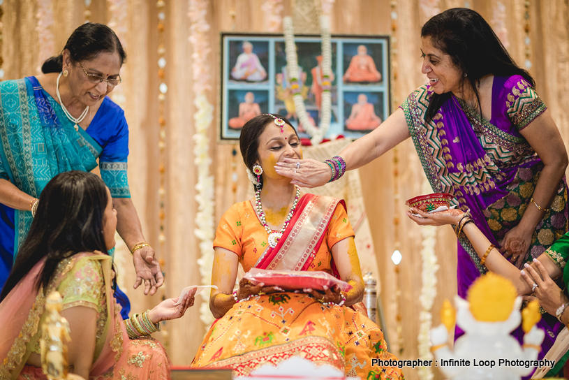 Family members applying haldi to the bride
