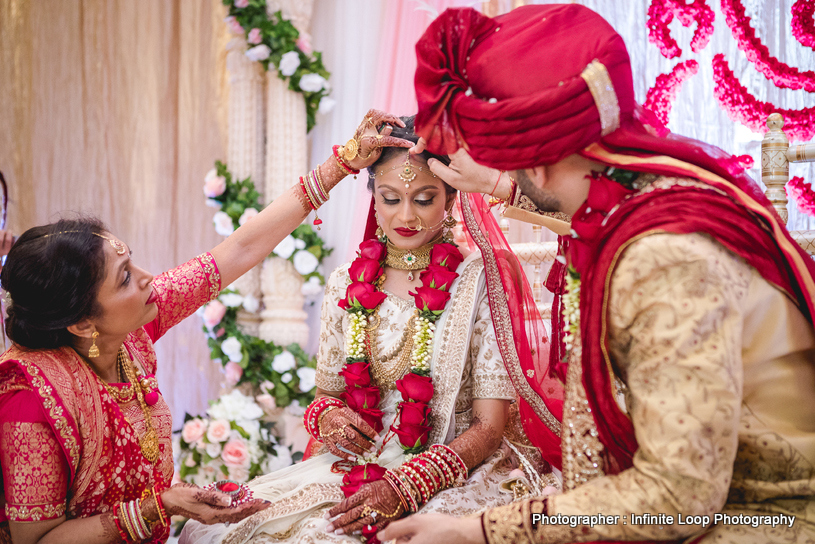 Indian groom applying sindoor 