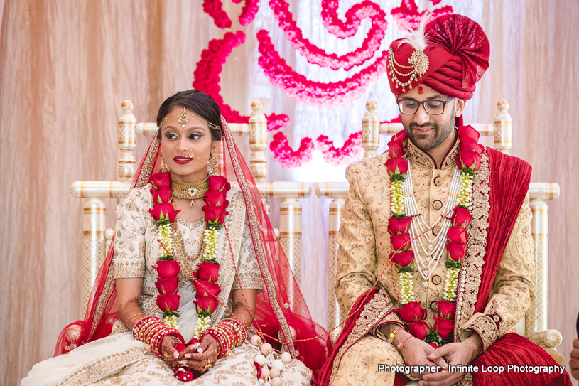 Indian couple sitting in the mandap