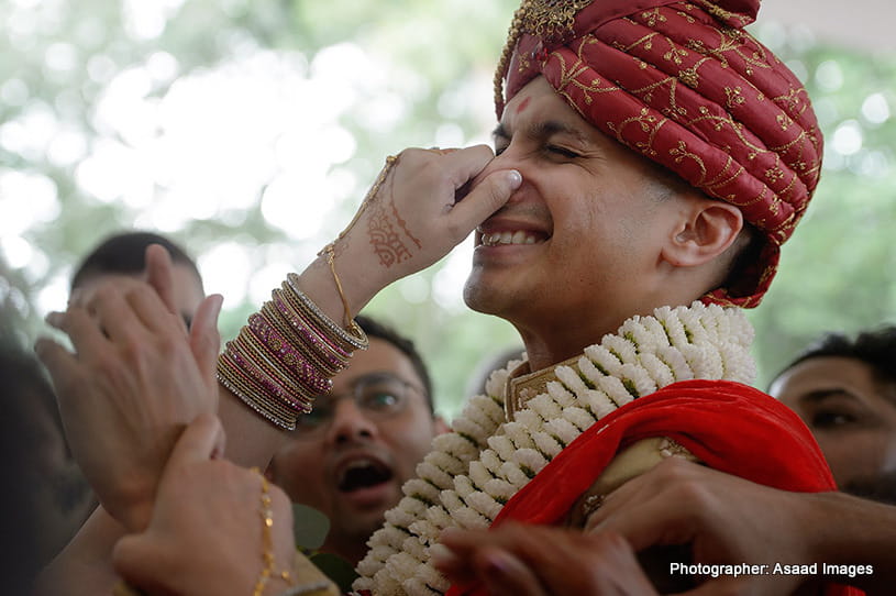 Mother In Law holding nose of indian Goom