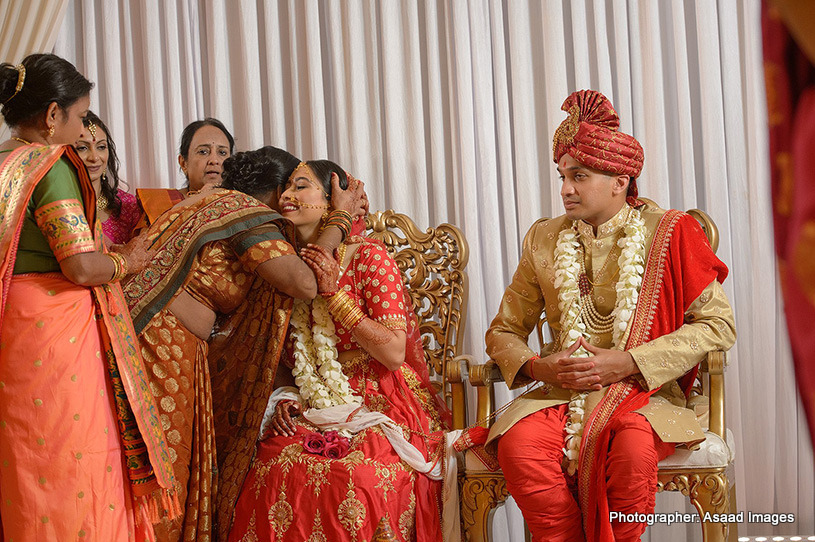 Indian Bride giving hug to mother