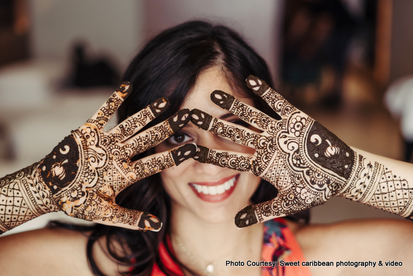 Bride posing with henna on her hands