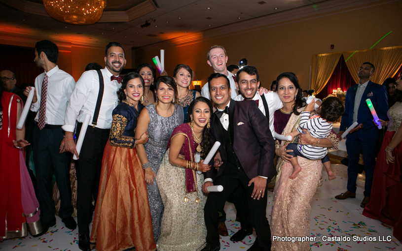Indian couple with bridesmaids and groomsmen capture at the reception