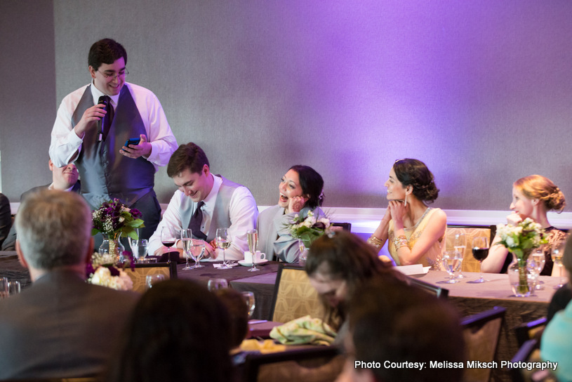 one of groomsmen saying something about groom