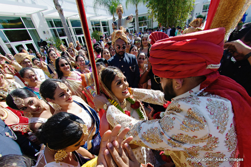 indian groom putting garland to indian bride's neck