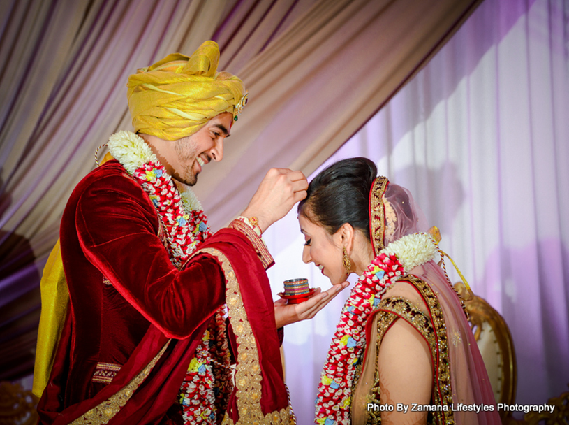 Groom applying sindoor to the groom