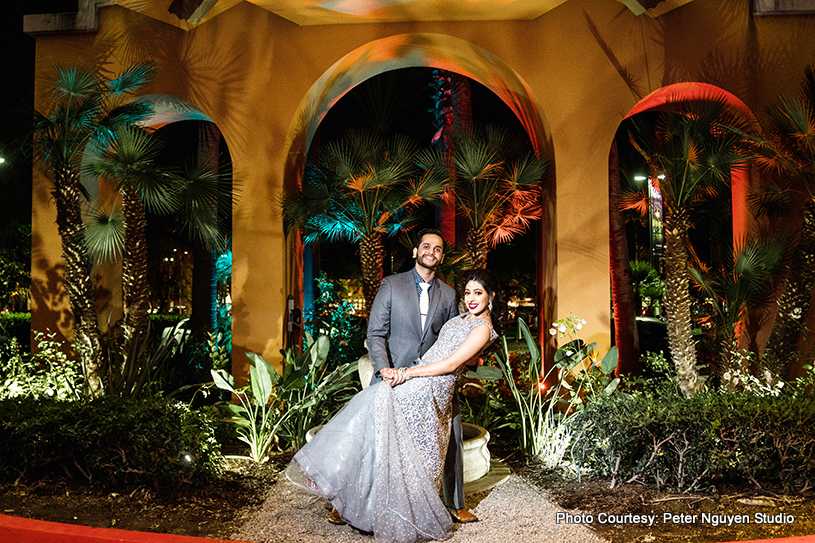 Bride sitting on grooms lap for a photo