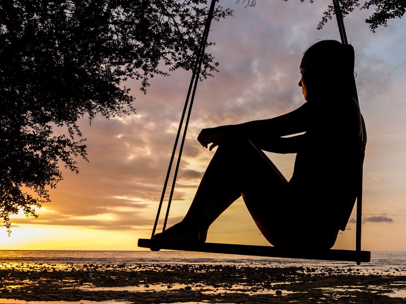 Girl Sitting alone on a swing