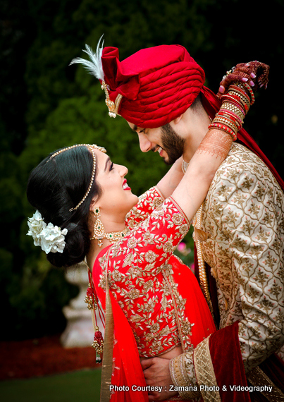 Indian bride and groom posing with their sangeet outfits