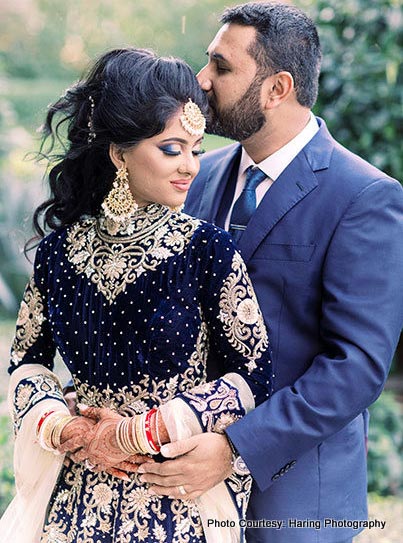 Groom kissing on forehead of bride