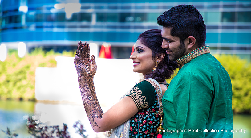 Beautiful indian bride showing henna art to groom