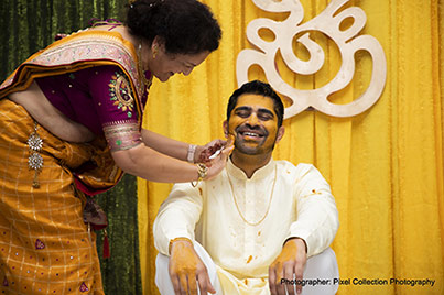 Family members Applying Haldi to indian Groom