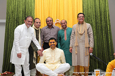 Indian wedding ritual of painting the groom with yellow turmeric paste