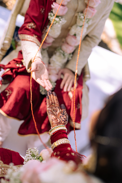 Indian Bride and groom under wedding mandap