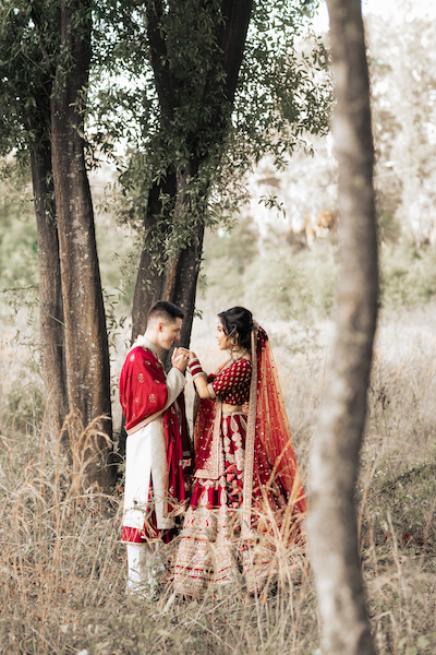 Indian brida and groom holding each other's hand