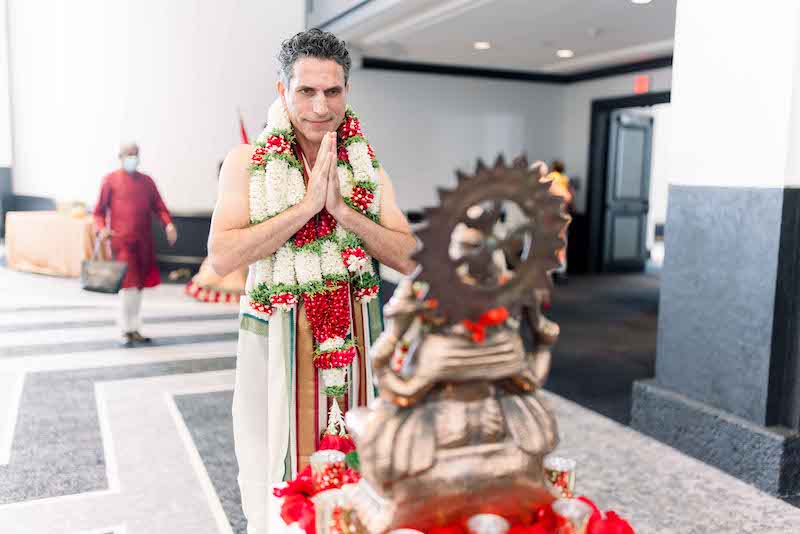 Indian Groom Holding hands in front of God