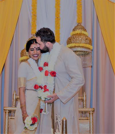 Groom Giving forehead kiss to Indian Bride