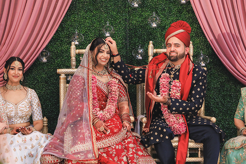 Indian groom applying Sindoor