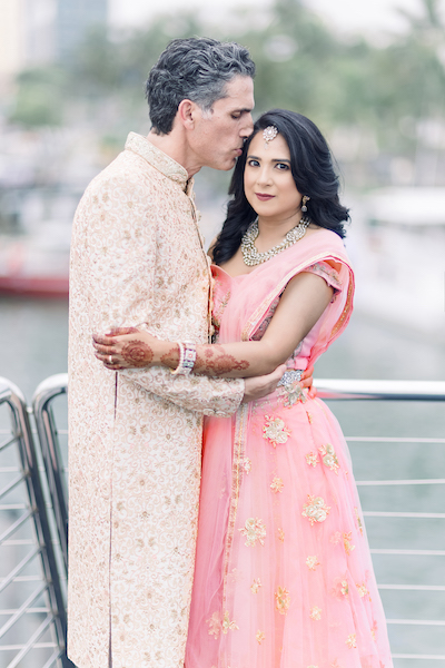 Groom kissing forehead of bride