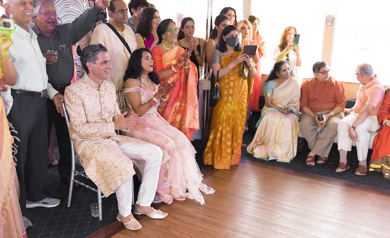 Indian couple cheering for the Sangeet performance