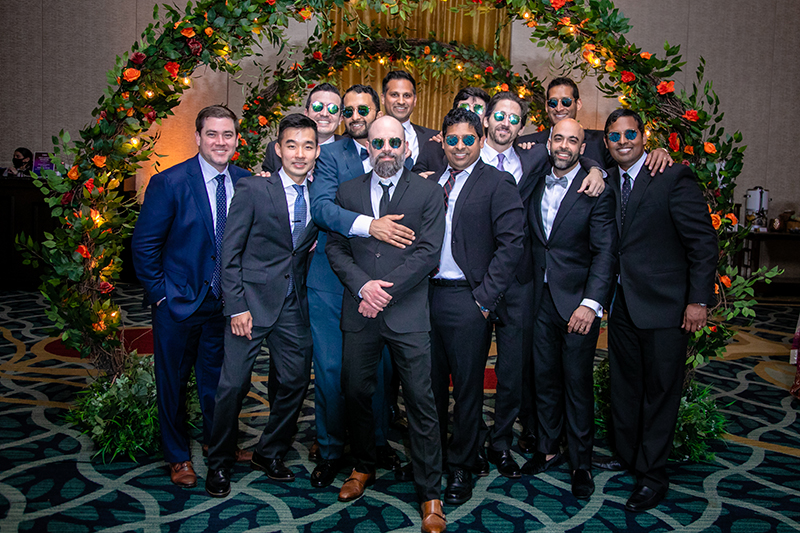 Groom posing with groomsmen at Wedding reception