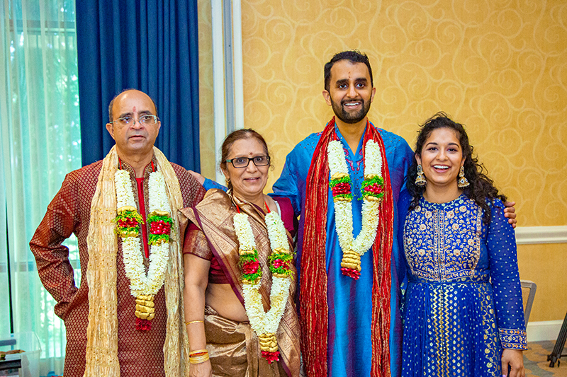 Indian groom posing with family