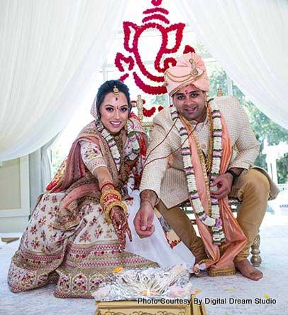 Indian Couple Performing Indian Ritual under Wedding Mandap