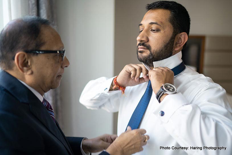 Father helping Indian Groom to get ready