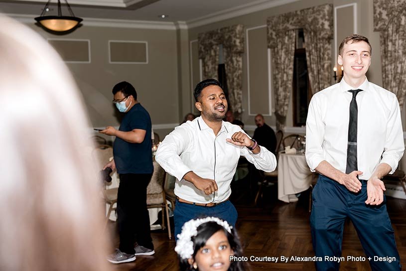 groom is dancing with his friend capture