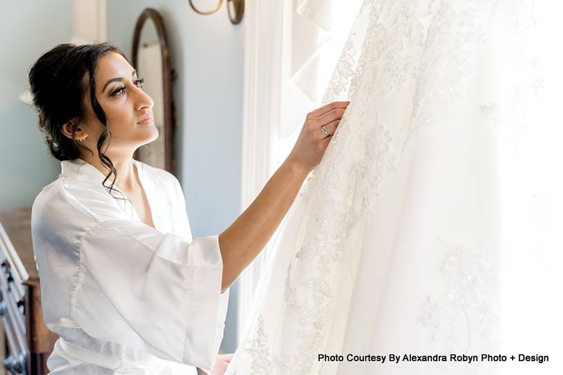 Indian bride looking at her wedding gown