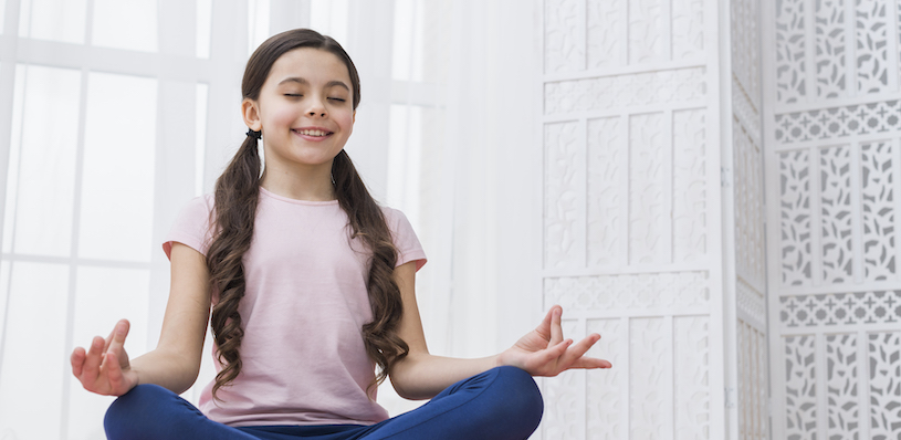 Happy Child doing Meditation