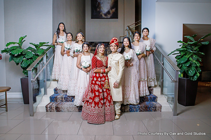 Indian Couple Posing with bridesmaids and groomsmen