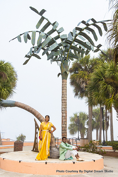 Indian couple sitting under tree capture