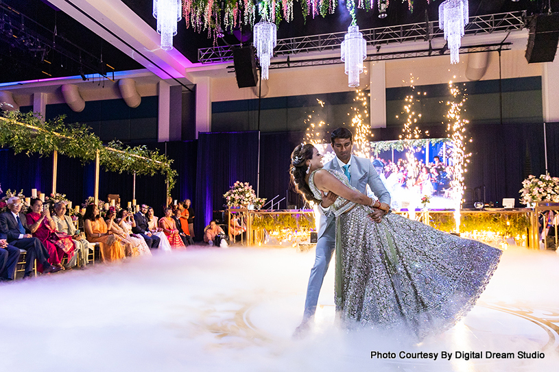 Indian wedding couple performing dance in reception ceremony