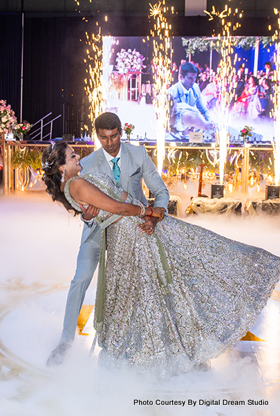 Indian Groom holding bride in his hand