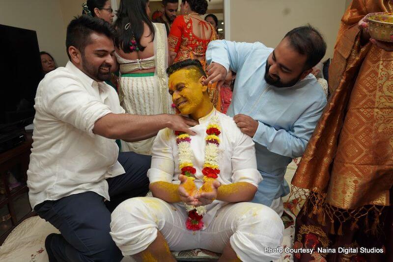 Groomsmen applying haldi to Indian Groom India Wedding Ritual