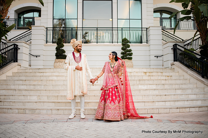 Indian Bride and groom holding each other hands 