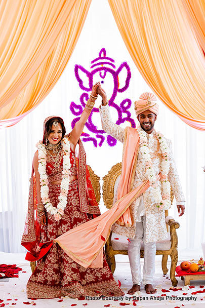 Indian bride and groom under wedding mandap